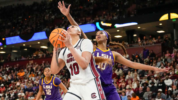 South Carolina center Kamilla Cardoso goes up for a shot defended by LSU forward Angel Reese.
